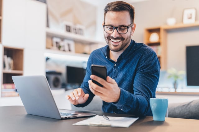 man-smiling-at-phone