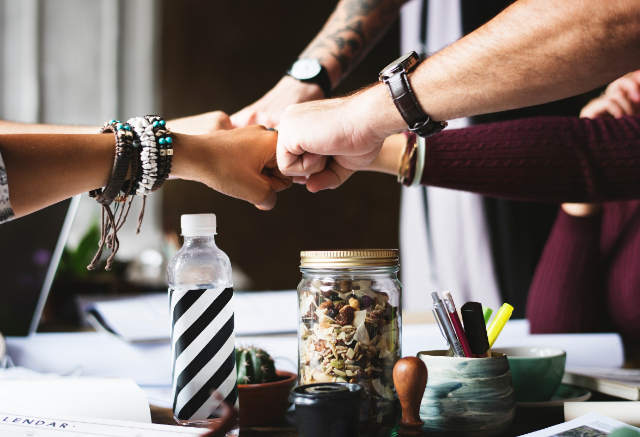 Celebratory fist bump when team work is enhanced after using able plus